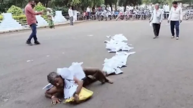 madhya-pradesh-man-rolls-outside-collectors-office-with-garland-of-1000page-complaint-watch